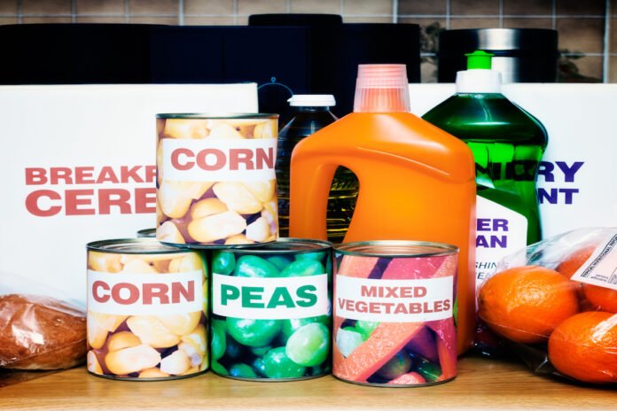 Variety of packaged foods and cleaning materials in kitchen