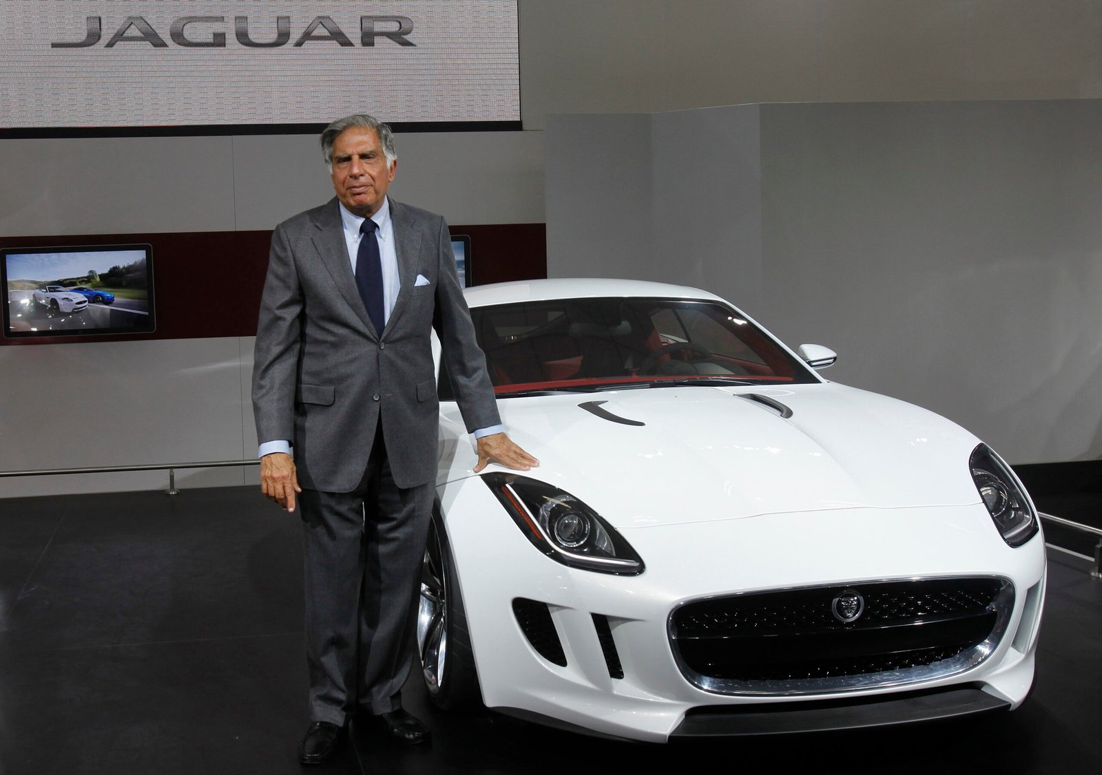 Chairman of Tata Group Tata poses with Jaguar's newly launched C-X16 car during India's Auto Expo, in New Delhi
